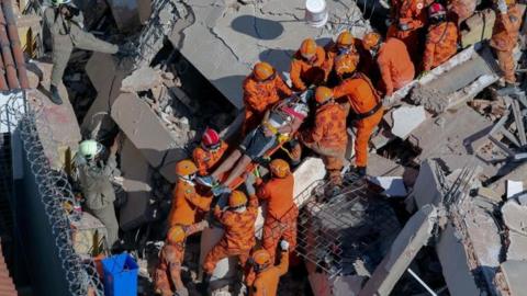 Firefighters rescue a survivor in Fortaleza, Brazil. Photo: 15 October 2019