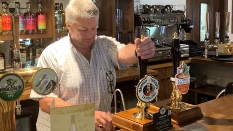 Bob Eden pulling a pint at The Raven Inn