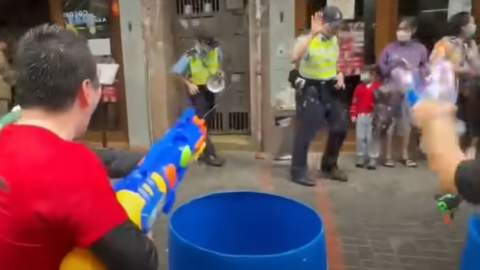 Man fires water gun at police during Songkran in Kowloon, Hong Kong