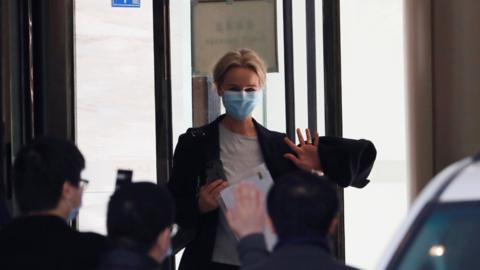 Thea Fisher, a member of the World Health Organisation (WHO) team tasked with investigating the origins of the coronavirus disease (COVID-19), waves as they leave their quarantine hotel in Wuhan, Hubei province, China January 28, 2021