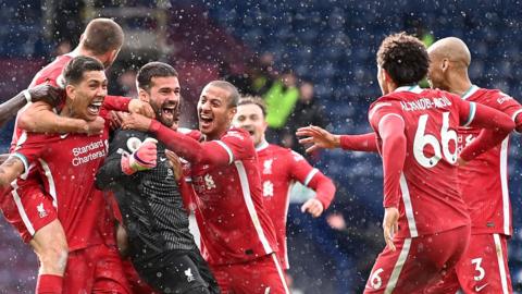 Alisson and team-mates celebrate