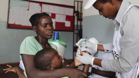 A child receives medical treatment at Agostinho Neto School after the passage of Cyclone Idai, in Beira City, central Mozambique