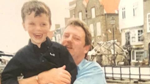 Old photo of Colin moon holding his son Jordan