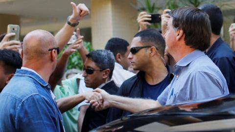Brazil's President Jair Bolsonaro greets supporters in Brasilia