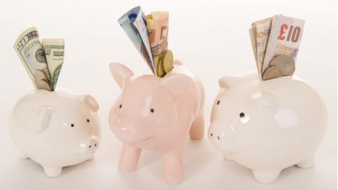 piggy banks with Scottish banknotes