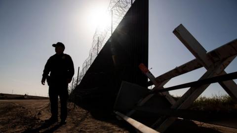 a border agent near the wall