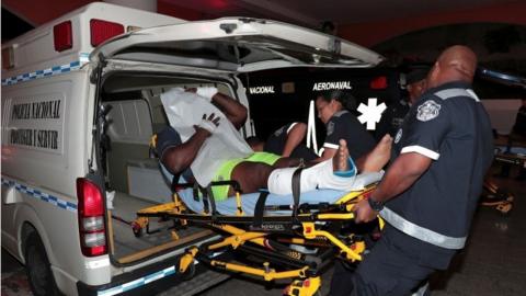 An injured inmate is carried on a stretcher into a hospital by police paramedics after a shootout among inmates at La Joyita prison, in Panama City, Panama December 17, 2019