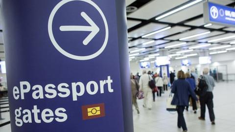 Passport eGate sign with an arrow pointing to the gates at Gatwick airport, London