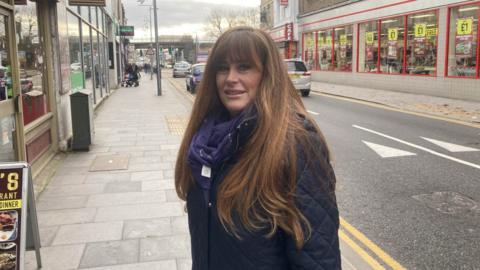 Kelly Tolhurst, MP for Rochester and Strood next to a road