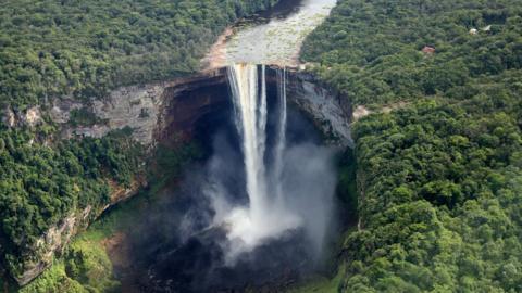 A pilot flies over the iconic Kaieteur Falls (The single largest Freefall waterfall in the world with a drop of 741 feet) in the Guyana Hinterland on day 13 of an official visit to the Caribbean on December 3, 2016 in Surama, Guyana.