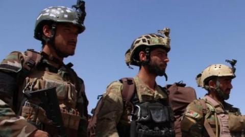 Afghan soldiers stand guard as people who were freed by Afghan security forces from a prison run by Taliban militants, are brought to a military base in Helmand, Afghanistan, 31 May 2018.