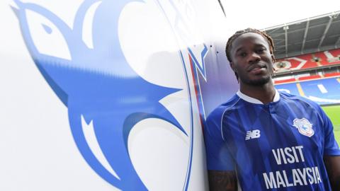 Ike Ugbo pictured in front of the Cardiff City badge