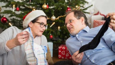 Couple opening unwanted Christmas presents