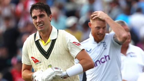 Pat Cummins celebrating Australia's win with Ben Stokes in the background