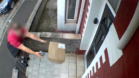 The delivery man flung a parcel over a gate instead of knocking on the door