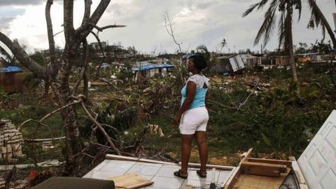 A lady stands on the remains of her damaged house in San Isidro, Puerto Rico after Hurricane Maria struck the island.