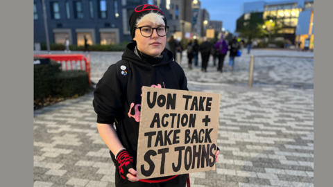 Student holding protest sign