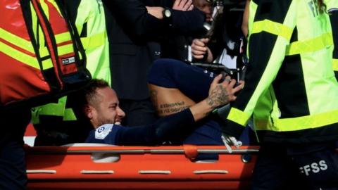 Neymar is carried off on a stretcher during PSG's match with Lille