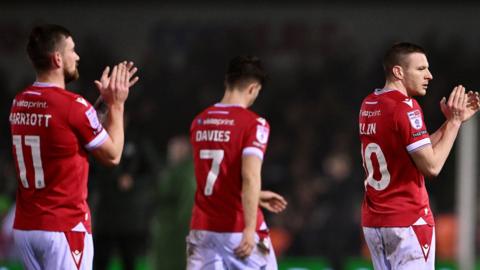 Wrexham players applaud their supporters