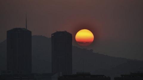 The sun sets in Caracas during a partial power cut on March 25, 2019.