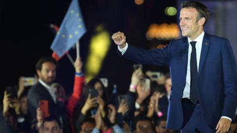 French President and La Republique en Marche (LREM) party candidate for re-election Emmanuel Macron celebrates after his victory in France's presidential election, at the Champ de Mars in Paris, on April 24, 2022.