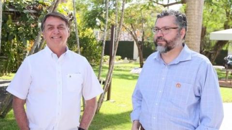 President Jair Bolsonaro stands news to Foreign Minister Ernesto Araujo in Brasilia, Brazil, July 4, 2020.