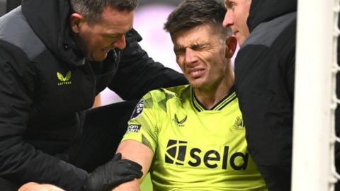 Newcastle United goalkeeper Nick Pope receives treatment for a shoulder injury