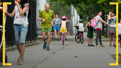 A competitor runs through pedestrians in the Sri Chinmoy Self Transcendence 3,100 Mile Race