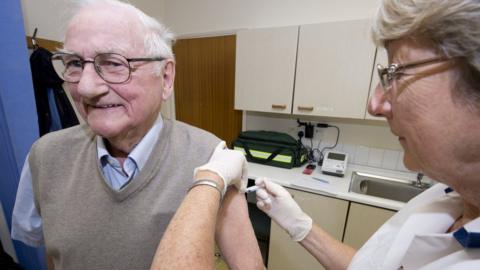 Elderly man gets flu jab