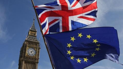 The British and EU flags over Parliament