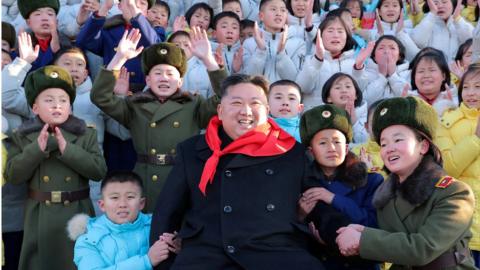 North Korean leader Kim Jong Un poses for a group photo with representatives of the Korean Children's Union (KCU) under North Korea's ruling Workers' Party in Pyongyang, North Korea, in this photo released on 1 January 2023 by North Korea's Korean Central News Agency