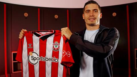 Romain Perraud holding up a Southampton shirt