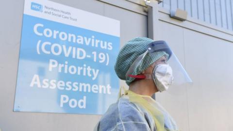 A nurse in protective equipment standing at a Covid-19 testing centre