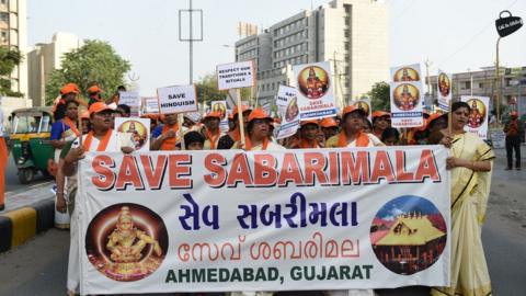 Indian Ayaappa devotees participate in a peaceful protest rally against the Supreme Court decision to allow women of all ages to enter inside the Kerala's Sabarimala temple, in Naroda area of Ahmedabad on October 14, 2018