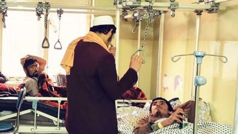 Three men inside a hospital in Afghanistan