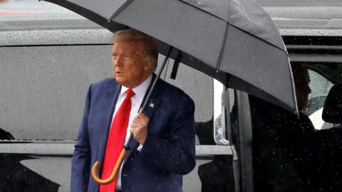 Trump with umbrella
