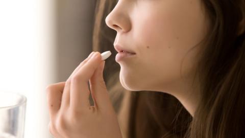 Woman taking pill