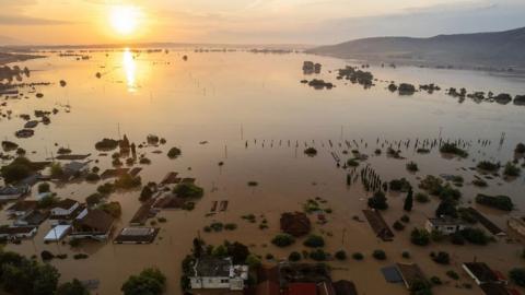 A drone view of a flooded village at sunrise in the Thessaly region of Greece