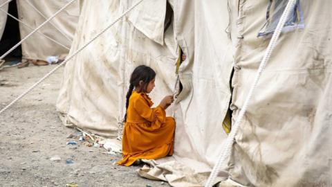 An Afghan child who fled due to the fighting between Taliban and Afghan security forces from northern provinces plays near her temporary shelter in a public park in Kabul, Afghanistan, 14 August (issued 15 August).