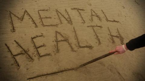 Mental Health written in sand