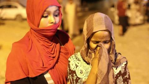 Girl weeps outside the detention centre after the attack