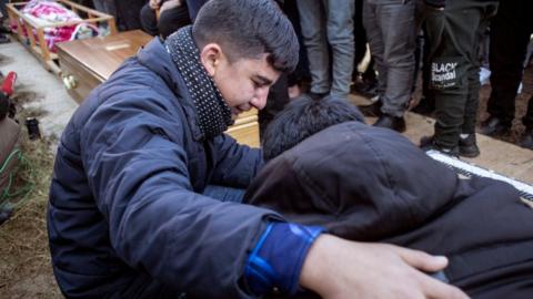 A funeral in Iraq for people who died trying to cross the Channel in November 2021