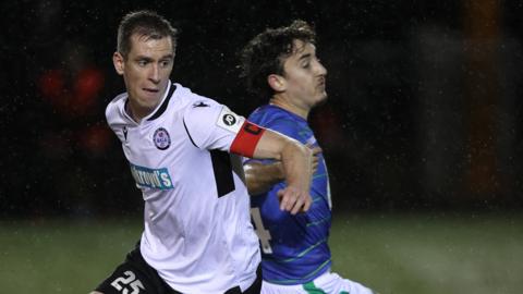 Bala v TNS: Chris Venables of Bala Town challenges for the ball