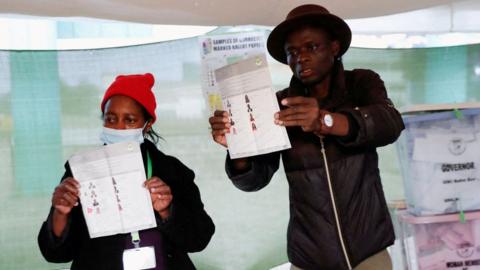 Electoral officials count cast ballot papers during the general election conducted by the Independent Electoral and Boundaries Commission (IEBC) at the close of the voting process at the Moi Avenue Primary School in Nairobi, Kenya August 9, 2022.