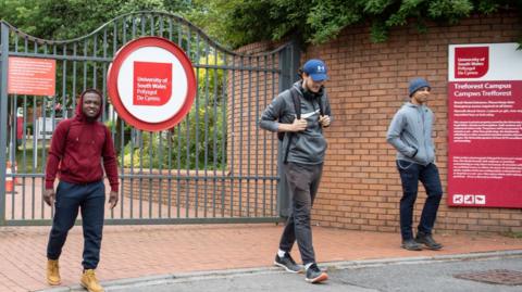 Students socially distance as they leave the University of South Wales campus in Treforest
