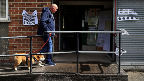 A man without a dog outside a polling station in Wales
