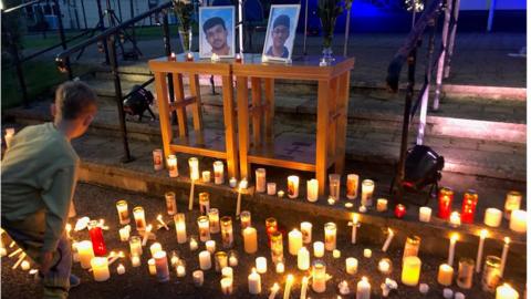 candles at vigil for Reuven Simon and Joseph Sebastian