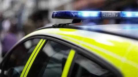 Top of a police car with blue lights on