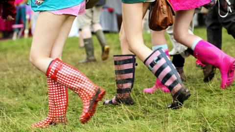 Festival goers in their wellies
