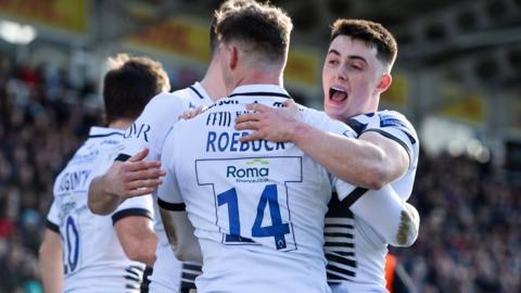 Sale Sharks player's celebrate Tom Roebuck's try